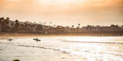 Best things to do in Ventura California - Michael Anderson - surfers heading out to the waves by VisitVentura