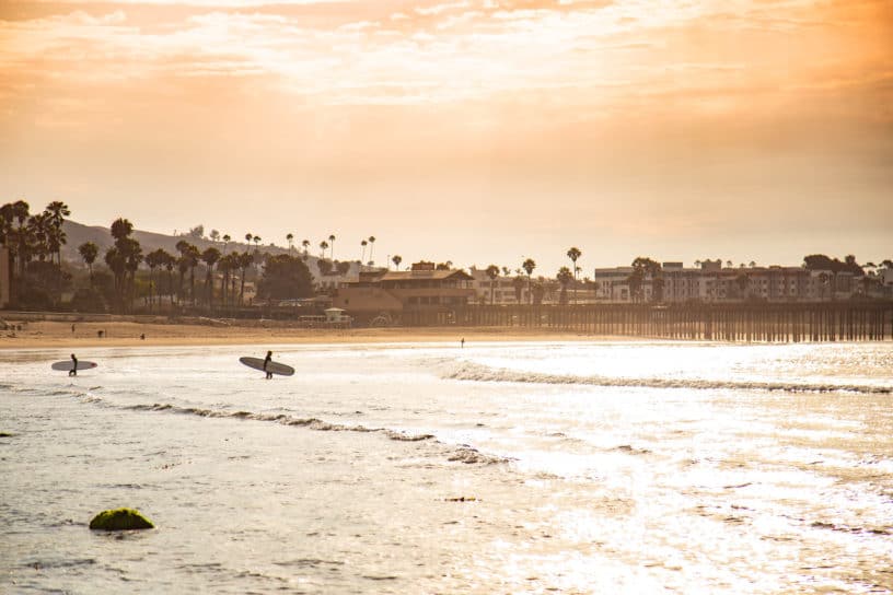 Best things to do in Ventura California - Michael Anderson - surfers heading out to the waves by VisitVentura
