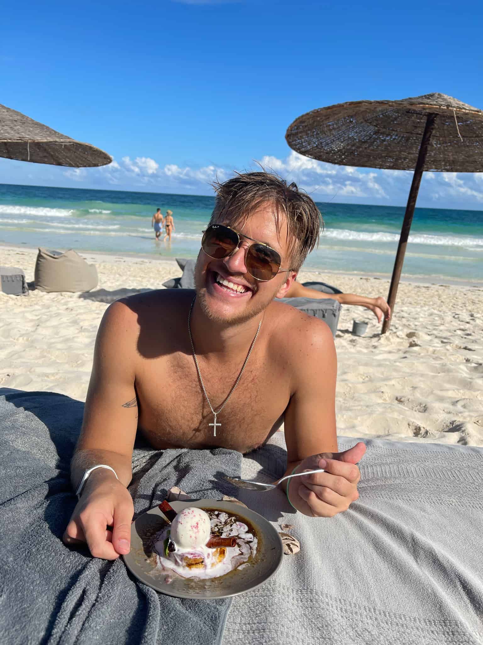 Luke Hajdukiewicz on the beach eating dessert