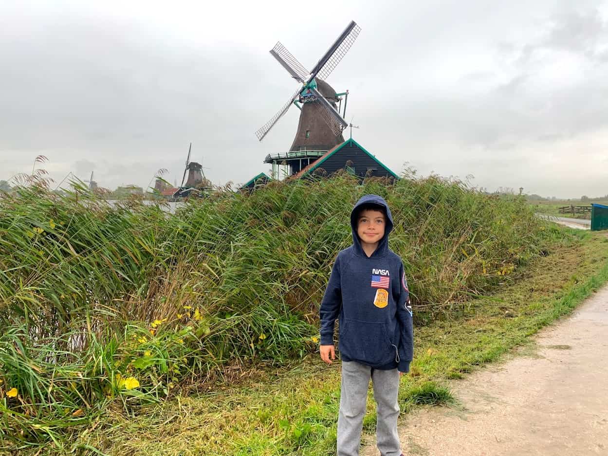 Best things to do in Amsterdam Netherlands - Kyle Kroeger - Timothy with windmills at Zaanse Schans