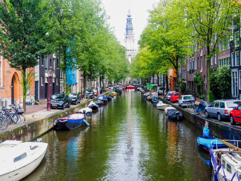 Best things to do in Amsterdam Netherlands - Kyle Kroeger - Zuiderkerk through a canal