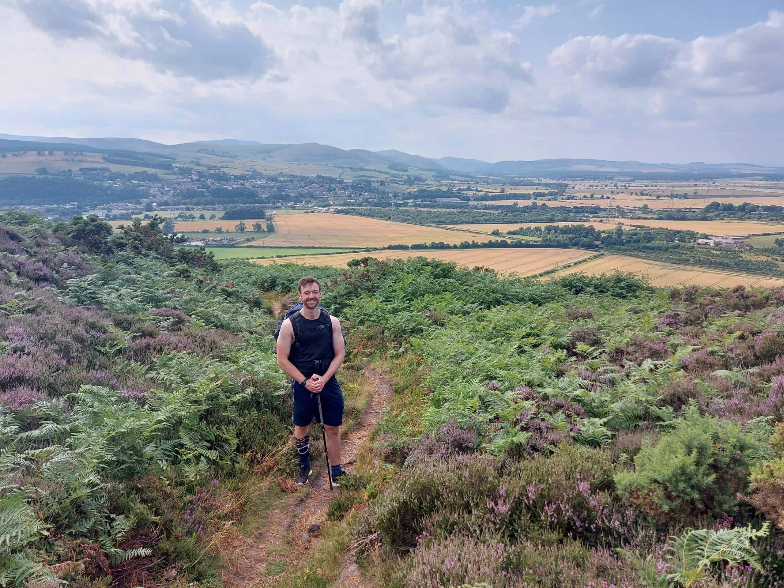 Best things to do in Newcastle UK - Paul McDougal on a hike overlooking the town of Wooler