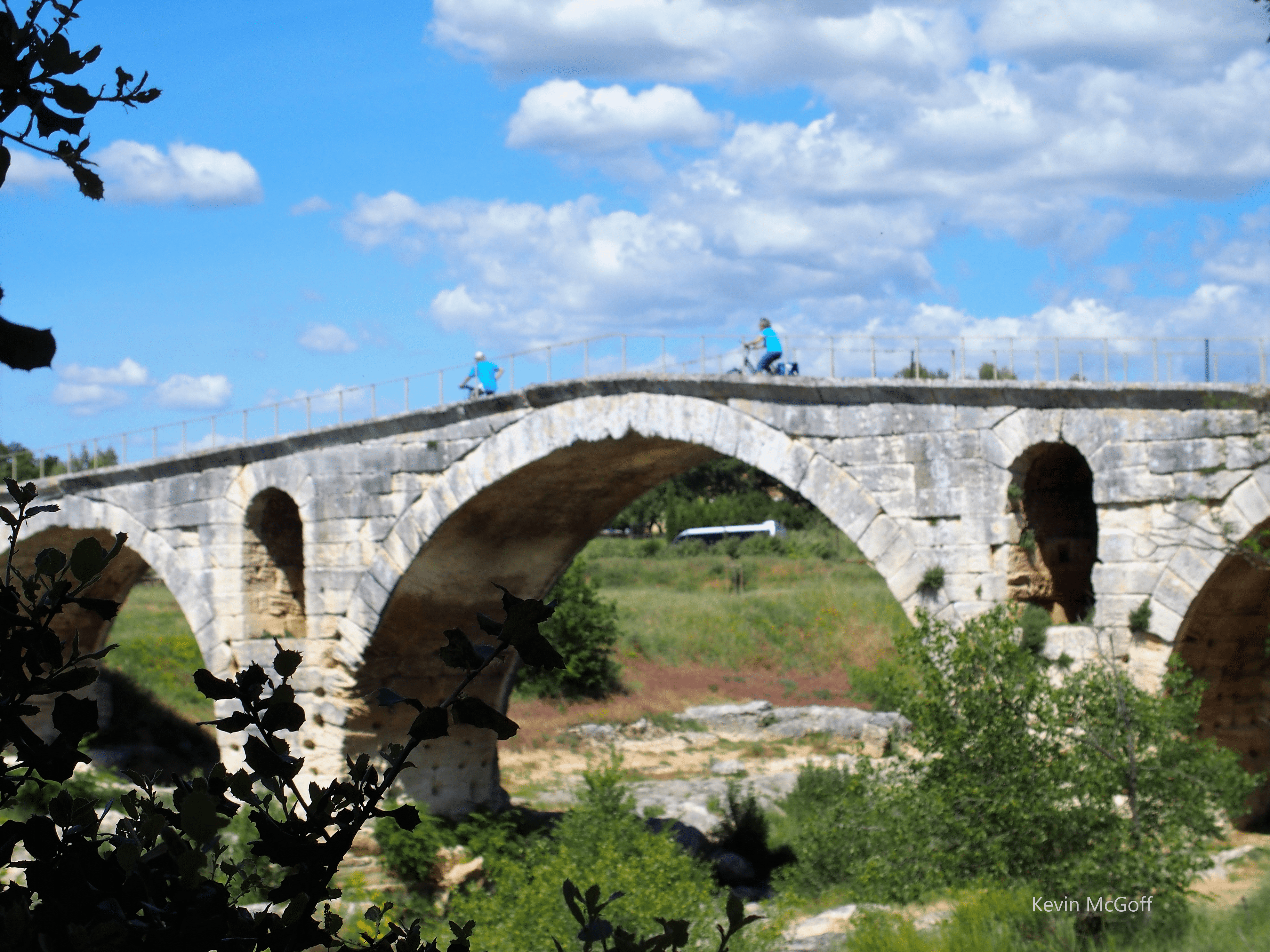Best things to do in L'Isle sur la Sorgue France - Kevin McGoff - cycling across a bridge
