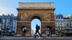 Best things to do in Paris France - Jay Swanson - walking across the Porte de Saint-Martin