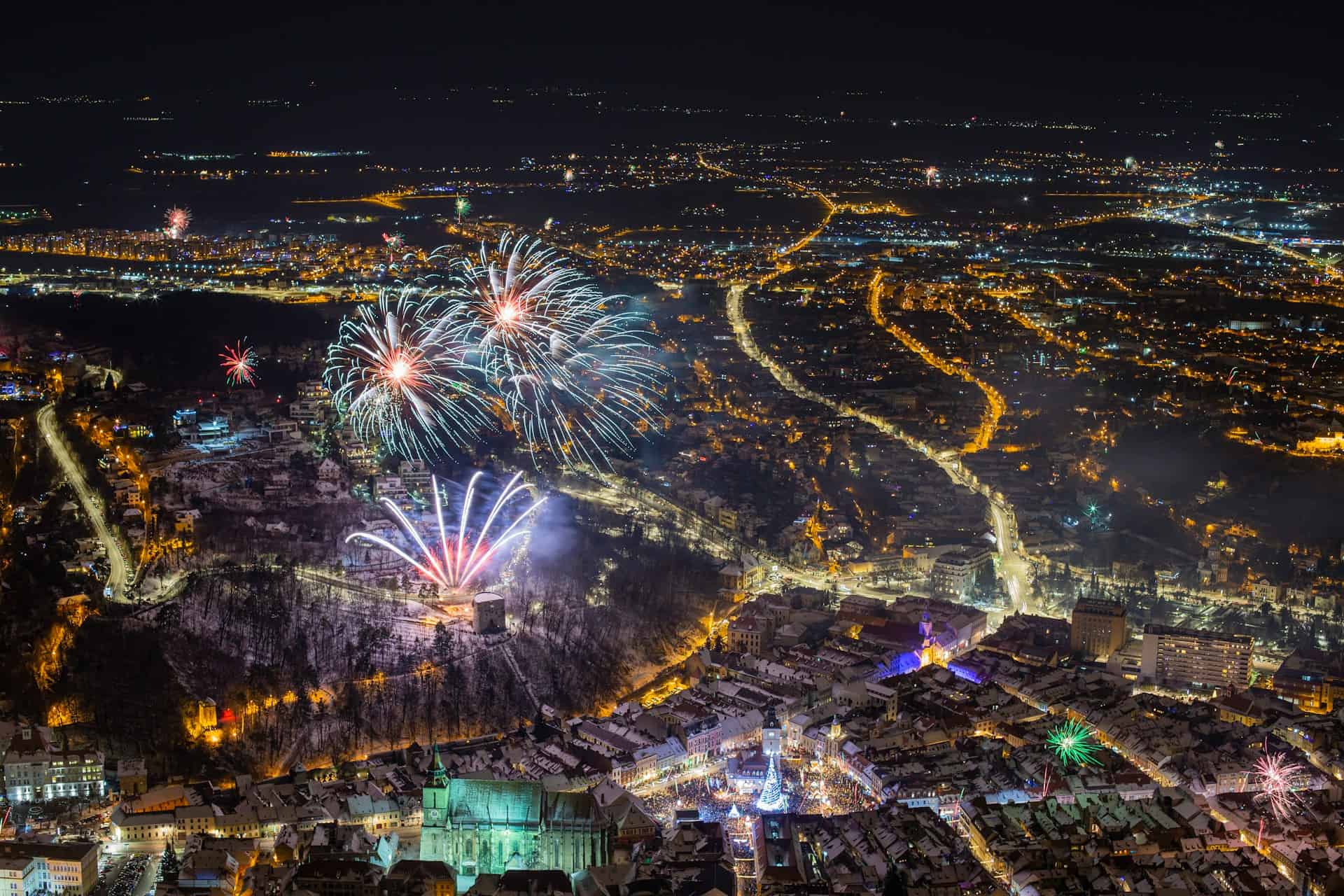 Best things to do in Brasov Romania - Marius Iliescu - Fireworks celebration above the city by Liviu Roman on Unsplash (1)