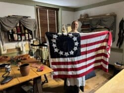 Best things to do in Philadelphia PA - Fayge Horesh - Betsy Ross house tour with Besty holding flag