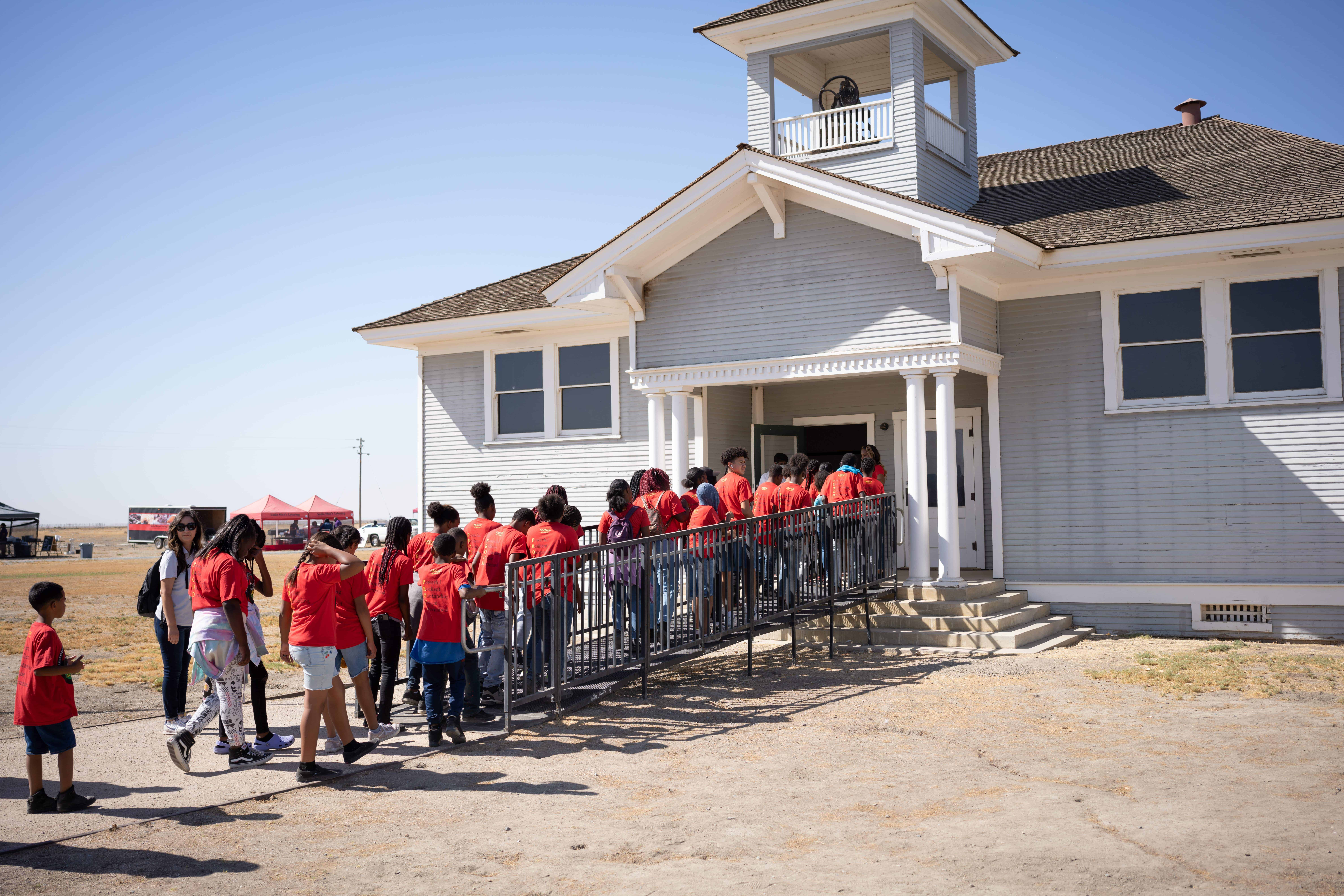 Best things to do in Allensworth CA - Carmen Setness - Guests entering schoolhouse at Allensworth